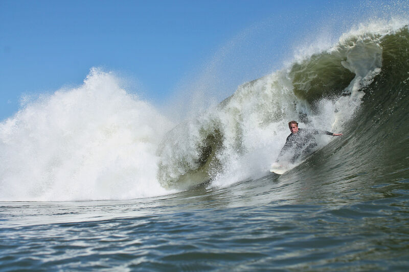 Surfer in wave — Skeleton Coast, Namibia
