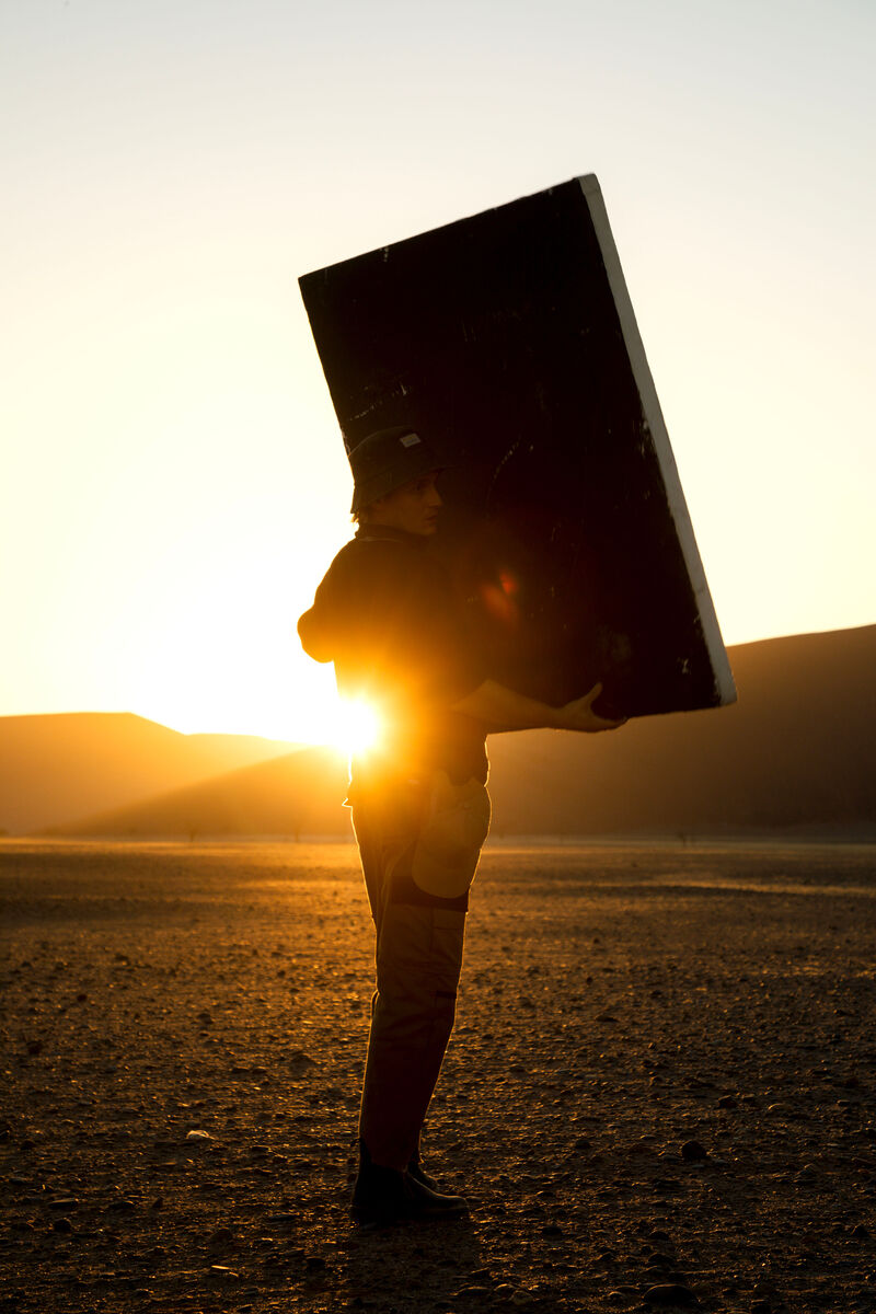 Brunello BTS — crew on dune, pre-dawn light