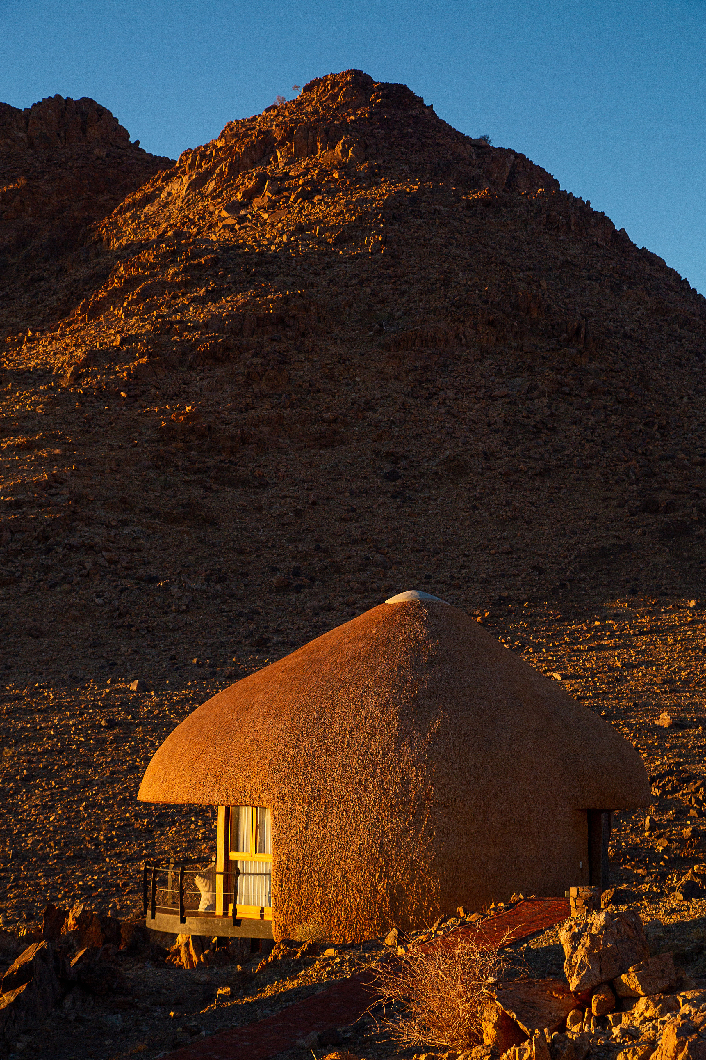 Thatched lodge architectural detail, golden hour